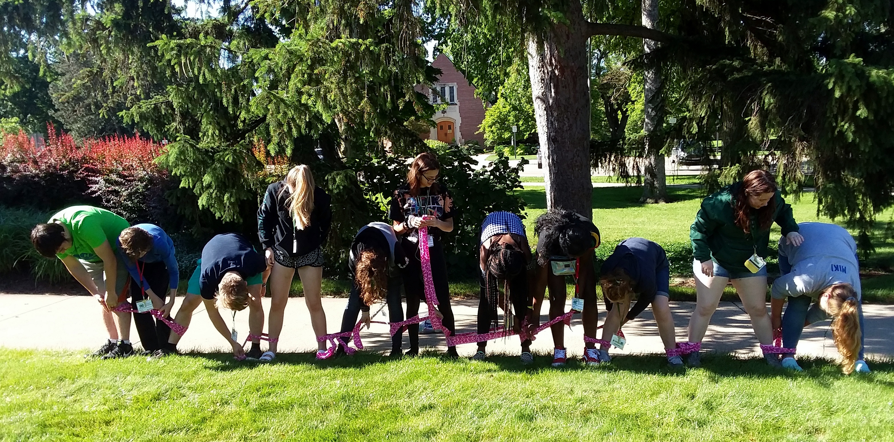 Kids with each leg tied to the person next to them trying to compete a race.